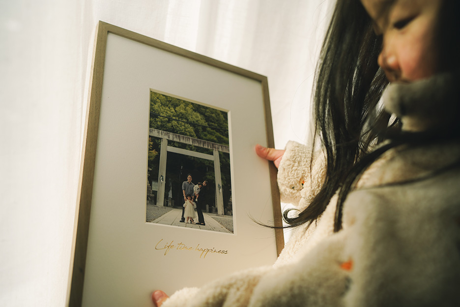 家族写真が入った「frame #001」を持っている写真